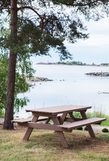 Kolberga picnic furniture in wood composite by the sea